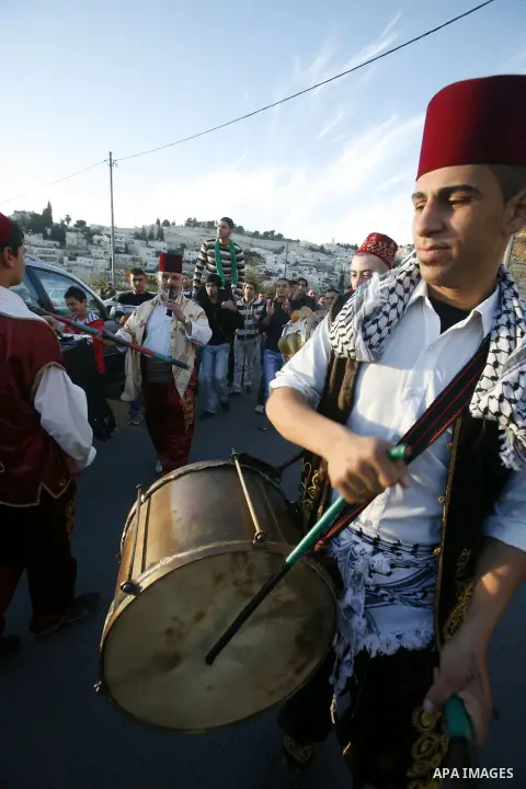 Palestinians celebrate after the Israeli authorities released prisoner Obaida al-Tawil in neighborhood of Bab al- Amood in Jerusalem on December 9, 2012. Al-Tawil spent 2 years in prison before the Israeli authorities re...