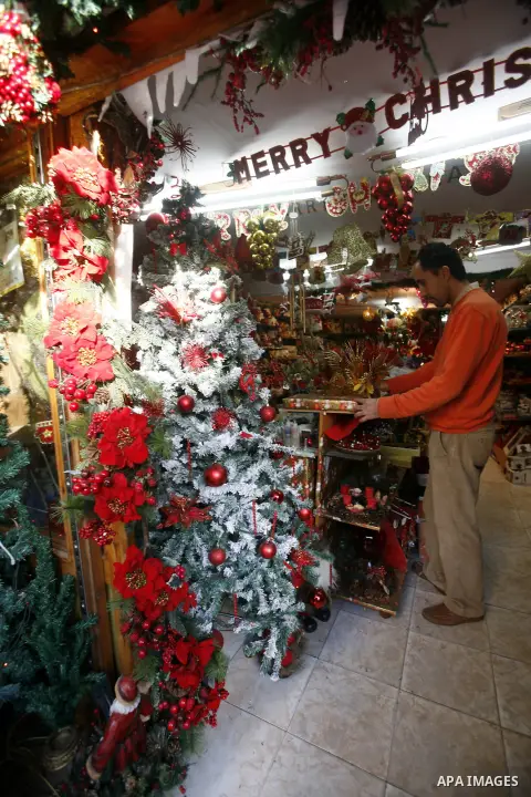 A Palestinian vendor decorates his store for the upcoming Christmas festivities in Jerusalem's old city, December 9, 2012. Christmas is celebrated across the globe on December 25 every year. Photo by Mahfouz Abu Turk