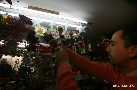 A Palestinian vendor decorates his store for the upcoming Christmas festivities in Jerusalem's old city, December 9, 2012. Christmas is celebrated across the globe on December 25 every year. Photo by Mahfouz Abu Turk