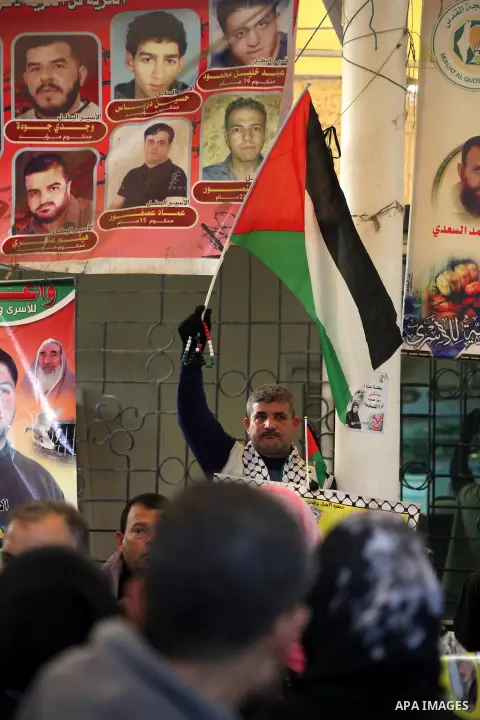 Palestinian women hold pictures of their prisoner relatives in Israeli jails as they gather in a weekly activity calling for their liberty at the Red Cross headquarters in Gaza City on December 10, 2012. Photo by Ashraf...