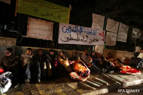 Palestinian teachers and graduates who were barred from employment by Ministry of Education, sit during a protest in front of Council of Ministers, in the West Bank city of Ramallah, December 10, 2012. Photo by Issam Rim...