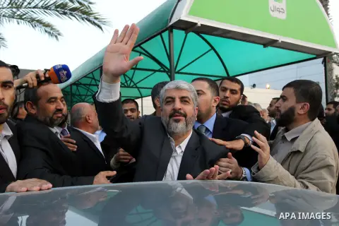 Hamas leader in exile Khaled Meshaal waves goodbye, upon his departure from the Gaza Strip on December 10, 2012 in Rafah, on the border with Egypt. Exiled Hamas chief Khaled Meshaal left Gaza after a historic first visit...