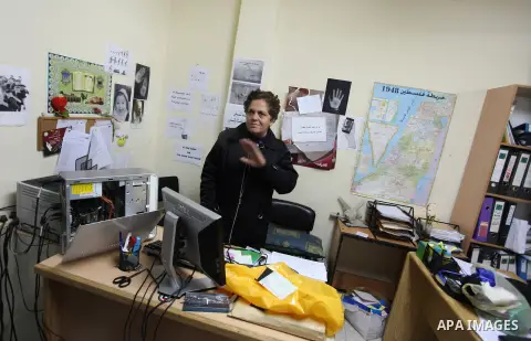 An employee checks a desk at the offices of the Addameer (Arabic for conscience) Prisoner Support and Human Rights offices, in the West Bank city of Ramallah, on December 11, 2012, after Israeli forces raided the offices...