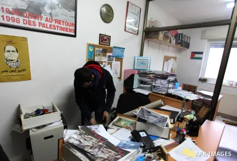 An employee checks a desk at the offices of the Addameer (Arabic for conscience) Prisoner Support and Human Rights offices, in the West Bank city of Ramallah, on December 11, 2012, after Israeli forces raided the offices...