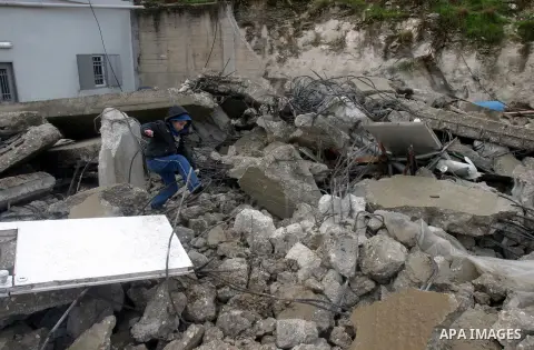 A Palestinian boy from Jabari family walks on the rubble of their house after it was demolished by Jerusalem municipality workers in the mostly Arab east Jerusalem neighborhood of al-Tur on December 11, 2012. Palestinian...