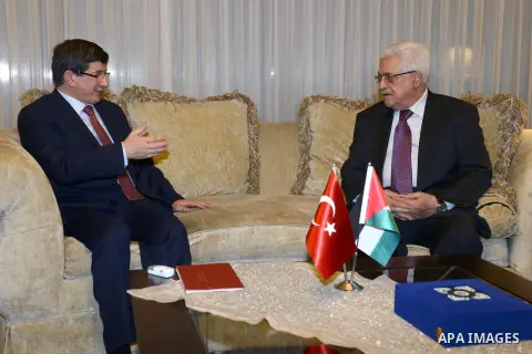 Palestinian President Mahmoud Abbas meets with Turkish Foreign Minister Ahmet Davutoglu during an official visit to Turkey, 11 December 2012. Photo by Thaer Ganaim