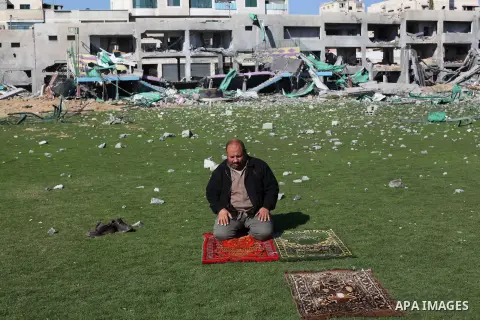Palestinian security guards pray at a soccer stadium, which witnesses said was destroyed in an Israeli air strike during an eight-day conflict, in Gaza City December 4, 2012. Eight days of Israeli air strikes on Gaza and...