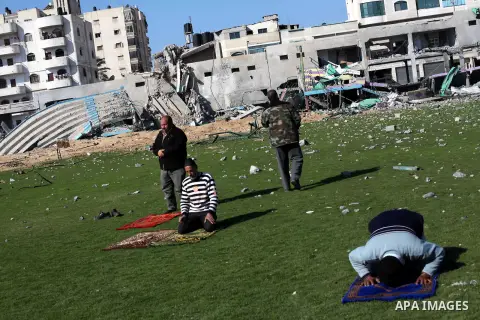 Palestinian security guards pray at a soccer stadium, which witnesses said was destroyed in an Israeli air strike during an eight-day conflict, in Gaza City December 4, 2012. Eight days of Israeli air strikes on Gaza and...