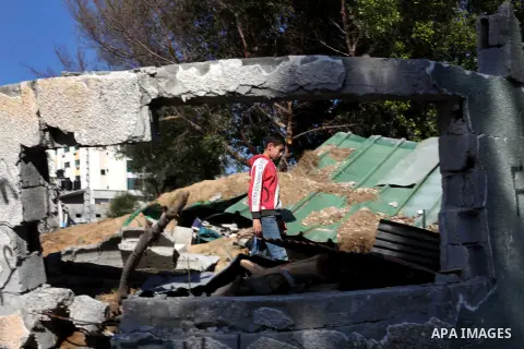 A Palestinian youth walks on the rubble at a soccer stadium, which witnesses said was destroyed in an Israeli air strike during an eight-day conflict, in Gaza City December 4, 2012. Eight days of Israeli air strikes on G...
