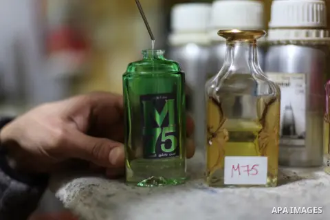 A Palestinian vendor blends perfume in bottles called M75 at his shop in Gaza City December 12, 2012. The Gaza vendor said the new perfume symbolises the name of the home-made M75 rocket. Hamas' armed wing said they had...