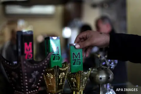 A Palestinian vendor displays perfume bottles called M75 at his shop in Gaza City December 12, 2012. The Gaza vendor said the new perfume symbolises the name of the home-made M75 rocket. Hamas' armed wing said they had f...