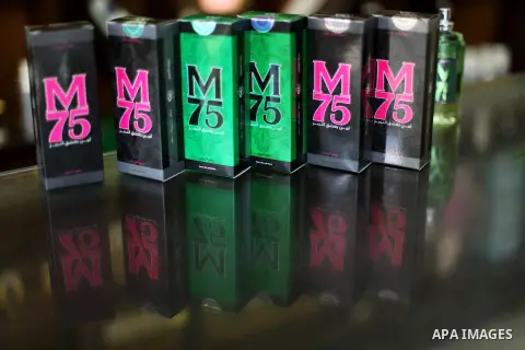 A Palestinian vendor displays perfume bottles called M75 at his shop in Gaza City December 12, 2012. The Gaza vendor said the new perfume symbolises the name of the home-made M75 rocket. Hamas' armed wing said they had f...