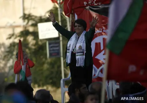 PFLP's Leila Khaled takes part in a rally organized by the Popular Front for the Liberation of Palestine (PFLP) to mark the 45th anniversary of the founding of the PFLP in Khan Younis southern Gaza strip, December 12, 20...