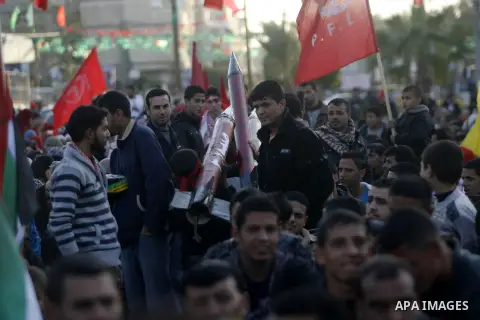 Supporters of the Popular Front for the Liberation of Palestine (PFLP) carry the party flag during a rally to mark the 45th anniversary of the founding of the PFLP in Khan Younis southern Gaza strip, December 12, 2012. P...