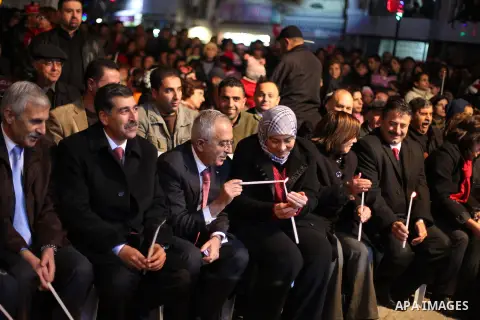 Palestinian prime minister Salam Fayyad attends a celebration by Palestinian Christians and Muslims to inaugurate Christmas' decorations in the West Bank city of Ramallah, on December 12, 2012. Photo by Issam Rimawi