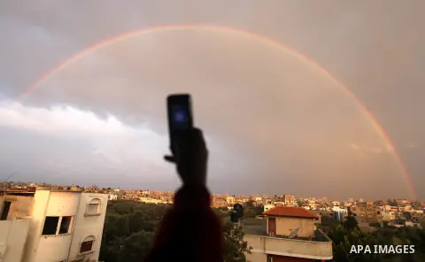 A rainbow is seen over the Gaza city after a rainy day on December 13, 2012. Photo by Majdi Fathi