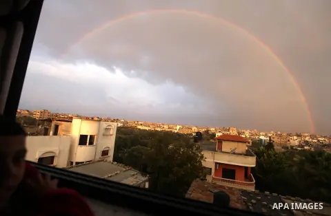 A rainbow is seen over the Gaza city after a rainy day on December 13, 2012. Photo by Majdi Fathi