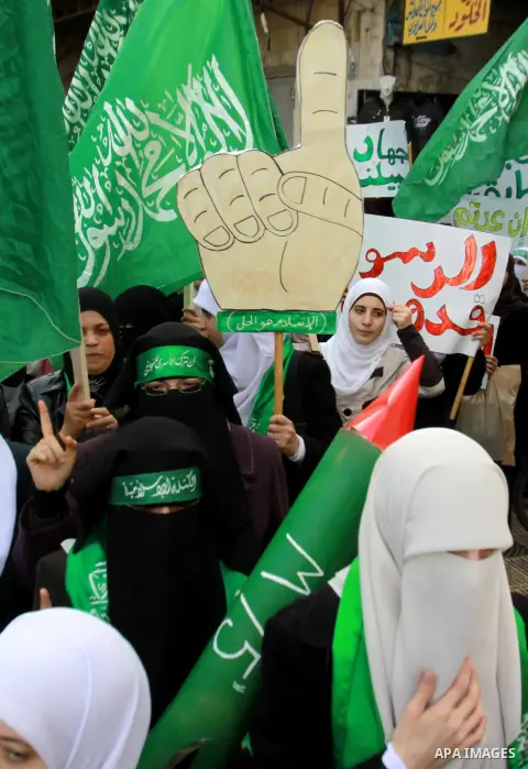 Palestinian Hamas supporters attend a Hamas rally marking the 25th anniversary of the Islamist movement's founding in the West Bank city of Nablus on December 13, 2012. Rapprochement between rival Palestinian factions Ha...