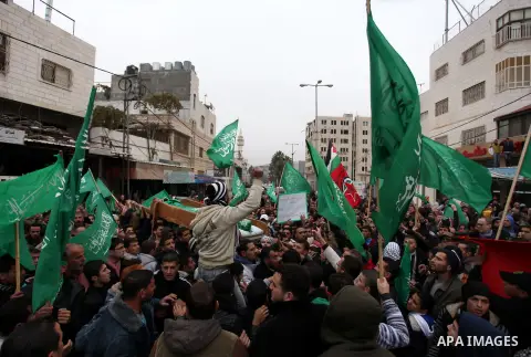 Palestinians carry the body of teenager Mohammed Ziad Salaymeh during his funeral in the West Bank city of Hebron, 13 December 2012. Israeli border police in the divided West Bank city of Hebron on 12 December shot dead...