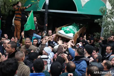 Palestinians carry the body of teenager Mohammed Ziad Salaymeh during his funeral in the West Bank city of Hebron, 13 December 2012. Israeli border police in the divided West Bank city of Hebron on 12 December shot dead...