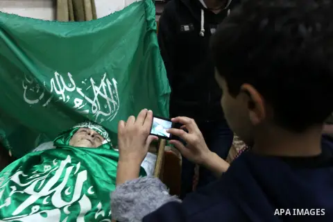 Relatives of Palestinian teenager Mohammed Ziad Salaymeh mourn next to his dead body during the funeral in the West Bank city of Hebron, 13 December 2012. Israeli border police in the divided West Bank city of Hebron on...
