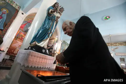 A Palestinian Christian attends a prayers at the Latin Catholic Church in Gaza City, Sunday, Dec. 16, 2012. Twal arrived in Gaza on Sunday to attend a celebration with Palestinians ahead of Christmas. Photo by Majdi Fath...