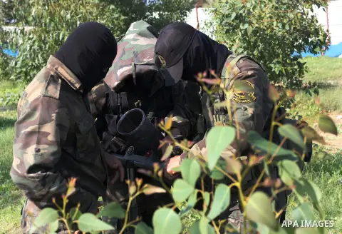 Palestinian militants from al-Quds Brigades the armed wing of the Islamic Jihad organization, stand around a rocket launcher during military exercises at an undisclosed location in the Hamas-run Gaza Strip in Gaza city o...