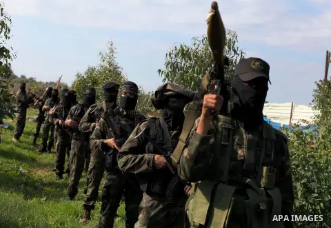 Palestinian militants from al-Quds Brigades the armed wing of the Islamic Jihad, stand during military exercises at an undisclosed location in the Hamas-run Gaza Strip in Gaza city on Dec 16. 2012. Hamas' armed wing and...