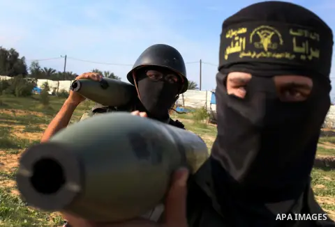Palestinian militants from al-Quds Brigades the armed wing of the Islamic Jihad organization, carry rockets during military exercises at an undisclosed location in the Hamas-run Gaza Strip in Gaza city on Dec 16. 2012. H...