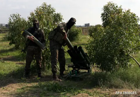 Palestinian militants from al-Quds Brigades the armed wing of the Islamic Jihad organization, stand around a rocket launcher during military exercises at an undisclosed location in the Hamas-run Gaza Strip in Gaza city o...