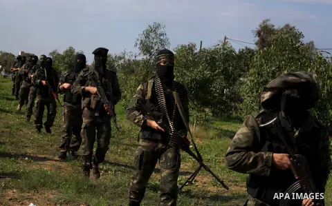 Palestinian militants from al-Quds Brigades the armed wing of the Islamic Jihad organization, walk during military exercises at an undisclosed location in the Hamas-run Gaza Strip in Gaza city on Dec 16. 2012. Hamas' arm...