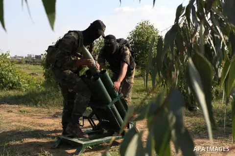 Palestinian militants from al-Quds Brigades the armed wing of the Islamic Jihad organization, stand around a rocket launcher during military exercises at an undisclosed location in the Hamas-run Gaza Strip in Gaza city o...