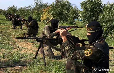 Palestinian militants from al-Quds Brigades the armed wing of the Islamic Jihad organization, sit during military exercises at an undisclosed location in the Hamas-run Gaza Strip in Gaza city on Dec 16. 2012. Hamas' arme...