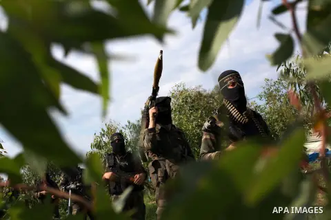 Palestinian militants from al-Quds Brigades the armed wing of the Islamic Jihad organization, walk during military exercises at an undisclosed location in the Hamas-run Gaza Strip in Gaza city on Dec 16. 2012. Hamas' arm...