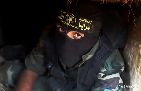 A Palestinian militant from al-Quds Brigades the armed wing of the Islamic Jihad organization, sits during military exercises at an undisclosed location in the Hamas-run Gaza Strip in Gaza city on Dec 16. 2012. Hamas' ar...