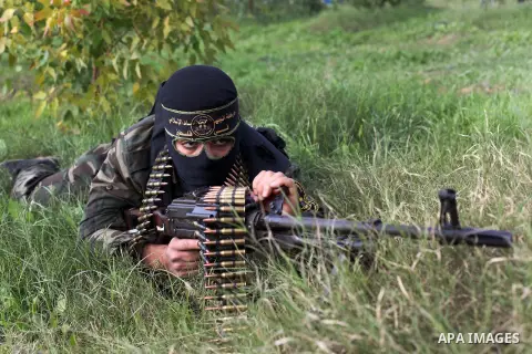 A Palestinian militant from al-Quds Brigades the armed wing of the Islamic Jihad organization, lies down during military exercises at an undisclosed location in the Hamas-run Gaza Strip in Gaza city on Dec 16. 2012. Hama...