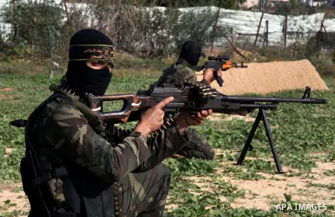 Palestinian militants from al-Quds Brigades the armed wing of the Islamic Jihad organization, sit during military exercises at an undisclosed location in the Hamas-run Gaza Strip in Gaza city on Dec 16. 2012. Hamas' arme...
