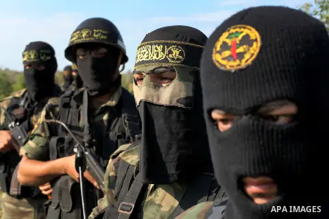 Palestinian militants from al-Quds Brigades the armed wing of the Islamic Jihad organization, stand during military exercises at an undisclosed location in the Hamas-run Gaza Strip in Gaza city on Dec 16. 2012. Hamas' ar...