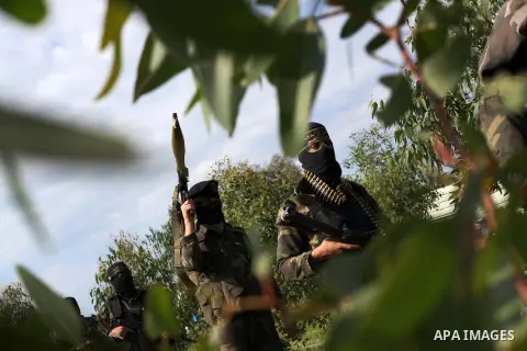 Palestinian militants from al-Quds Brigades the armed wing of the Islamic Jihad organization, walk during military exercises at an undisclosed location in the Hamas-run Gaza Strip in Gaza city on Dec 16. 2012. Hamas' arm...