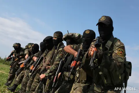 Palestinian militants from al-Quds Brigades the armed wing of the Islamic Jihad organization, walk during military exercises at an undisclosed location in the Hamas-run Gaza Strip in Gaza city on Dec 16. 2012. Hamas' arm...
