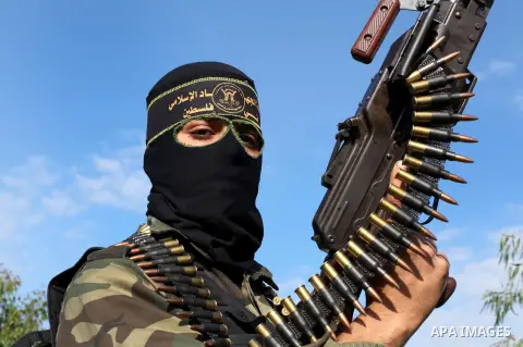 A Palestinian militant from al-Quds Brigades the armed wing of the Islamic Jihad organization, stands during military exercises at an undisclosed location in the Hamas-run Gaza Strip in Gaza city on Dec 16. 2012. Hamas'...