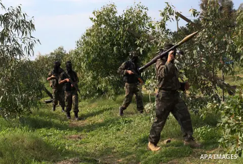 Palestinian militants from al-Quds Brigades the armed wing of the Islamic Jihad organization, walk during military exercises at an undisclosed location in the Hamas-run Gaza Strip in Gaza city on Dec 16. 2012. Hamas' arm...