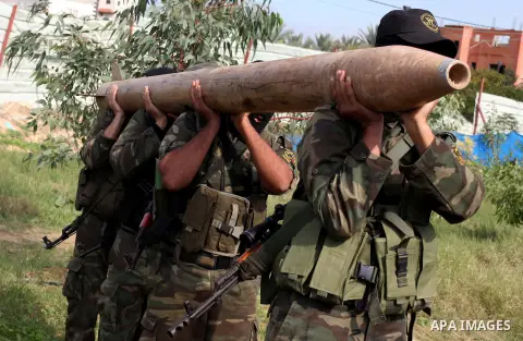 Palestinian militants from al-Quds Brigades the armed wing of the Islamic Jihad organization, carry a rocket during military exercises at an undisclosed location in the Hamas-run Gaza Strip in Gaza city on Dec 16. 2012....