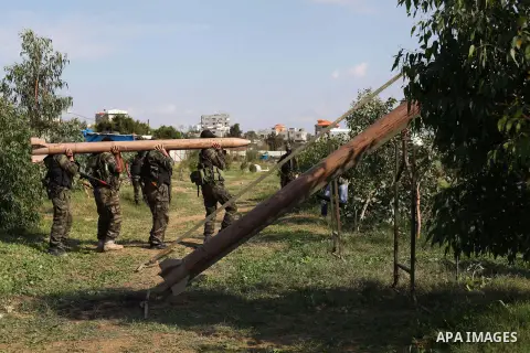 Palestinian militants from al-Quds Brigades the armed wing of the Islamic Jihad organization, stand around a rocket launcher during military exercises at an undisclosed location in the Hamas-run Gaza Strip in Gaza city o...