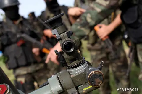 Palestinian militants from al-Quds Brigades the armed wing of the Islamic Jihad organization, stand around a rocket launcher during military exercises at an undisclosed location in the Hamas-run Gaza Strip in Gaza city o...