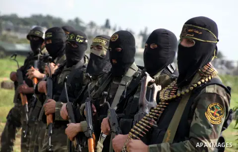 Palestinian militants from al-Quds Brigades the armed wing of the Islamic Jihad organization, stand during military exercises at an undisclosed location in the Hamas-run Gaza Strip in Gaza city on Dec 16. 2012. Hamas' ar...
