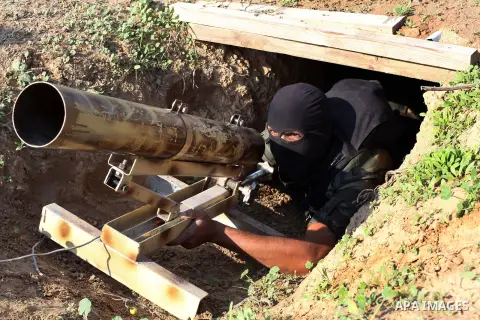 A Palestinian militant from al-Quds Brigades the armed wing of the Islamic Jihad organization, carries a rocket launcher during military exercises at an undisclosed location in the Hamas-run Gaza Strip in Gaza city on De...