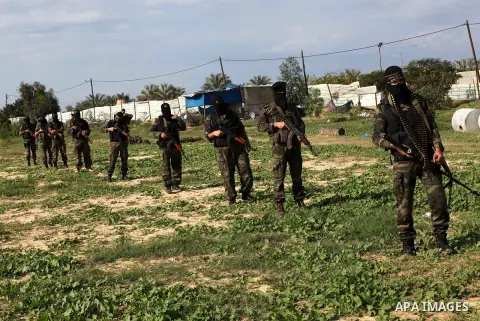 Palestinian militants from al-Quds Brigades the armed wing of the Islamic Jihad organization, walk during military exercises at an undisclosed location in the Hamas-run Gaza Strip in Gaza city on Dec 16. 2012. Hamas' arm...
