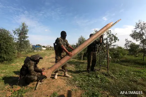 Palestinian militants from al-Quds Brigades the armed wing of the Islamic Jihad organization, stand around a rocket launcher during military exercises at an undisclosed location in the Hamas-run Gaza Strip in Gaza city o...