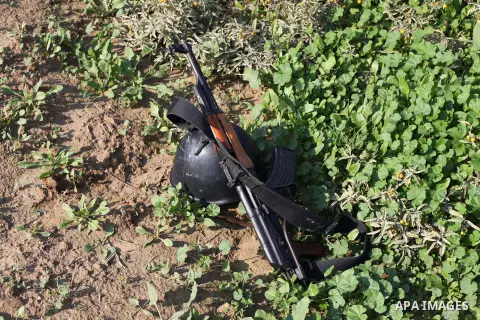 An AK47 rifle and a helmet is seen during military exercises for militant from al-Quds Brigades the armed wing of the Islamic Jihad organization, at an undisclosed location in the Hamas-run Gaza Strip in Gaza city on Dec...